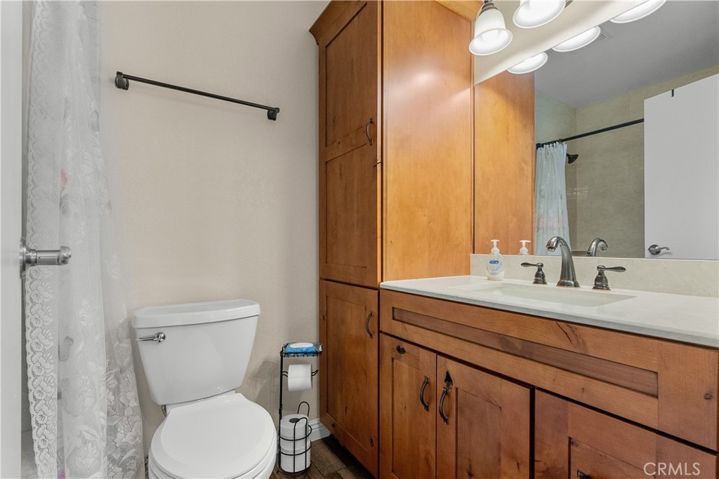 28152 Robin Avenue Saugus, CA 91350 - Photo 25 of 49 a bathroom with a granite countertop sink mirror vanity and toilet