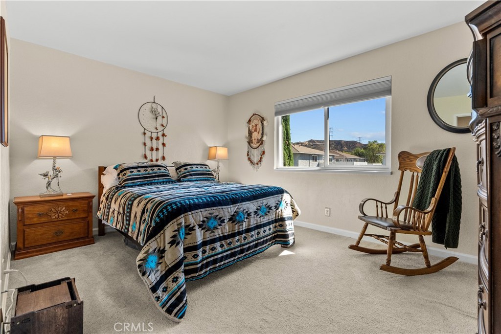 28152 Robin Avenue Saugus, CA 91350 - Photo 30 of 49 a spacious bedroom with a bed a mirror with the dresser and mirror