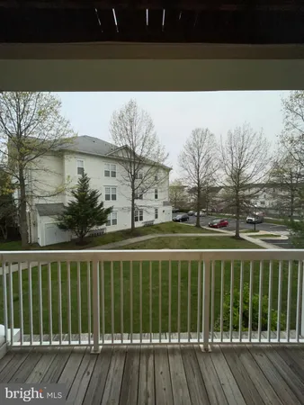 a view of a balcony with wooden floor