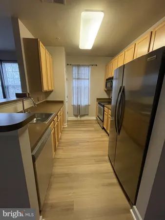 a kitchen with stainless steel appliances a refrigerator and a stove
