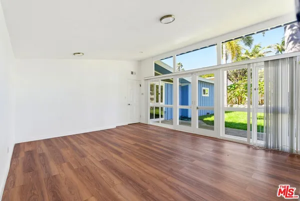 a view of room with hardwood floor and window
