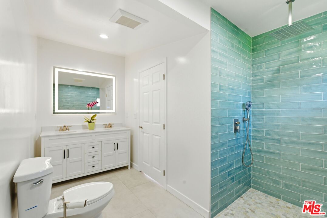 26 Packet Road Rancho Palos Verdes, CA 90275 - Photo 20 of 40 a bathroom with a toilet a sink a mirror a shower a vanity and window