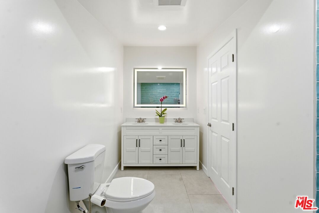 26 Packet Road Rancho Palos Verdes, CA 90275 - Photo 21 of 40 a bathroom with a sink a toilet and mirror