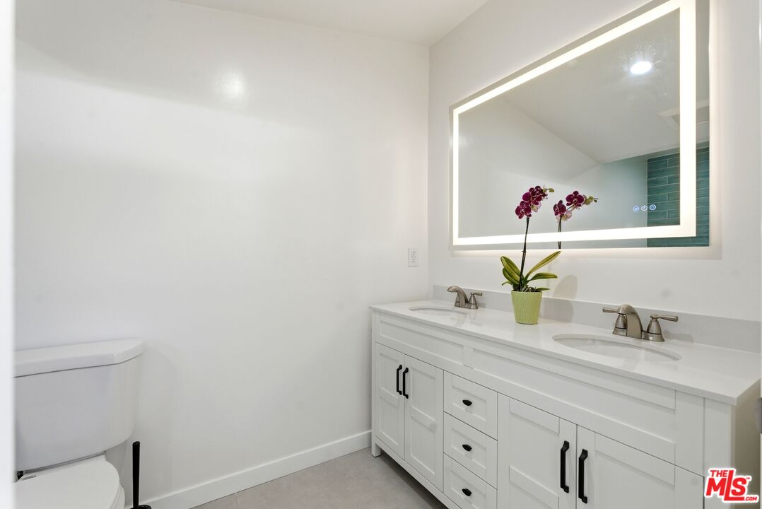 26 Packet Road Rancho Palos Verdes, CA 90275 - Photo 22 of 40 a bathroom with a granite countertop sink and a mirror