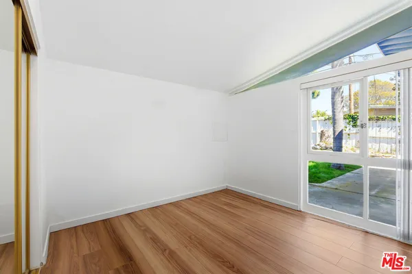 a view of room with wooden floor