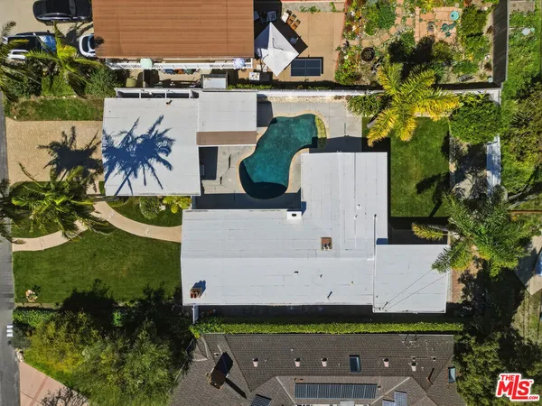 an aerial view of a residential houses with outdoor space
