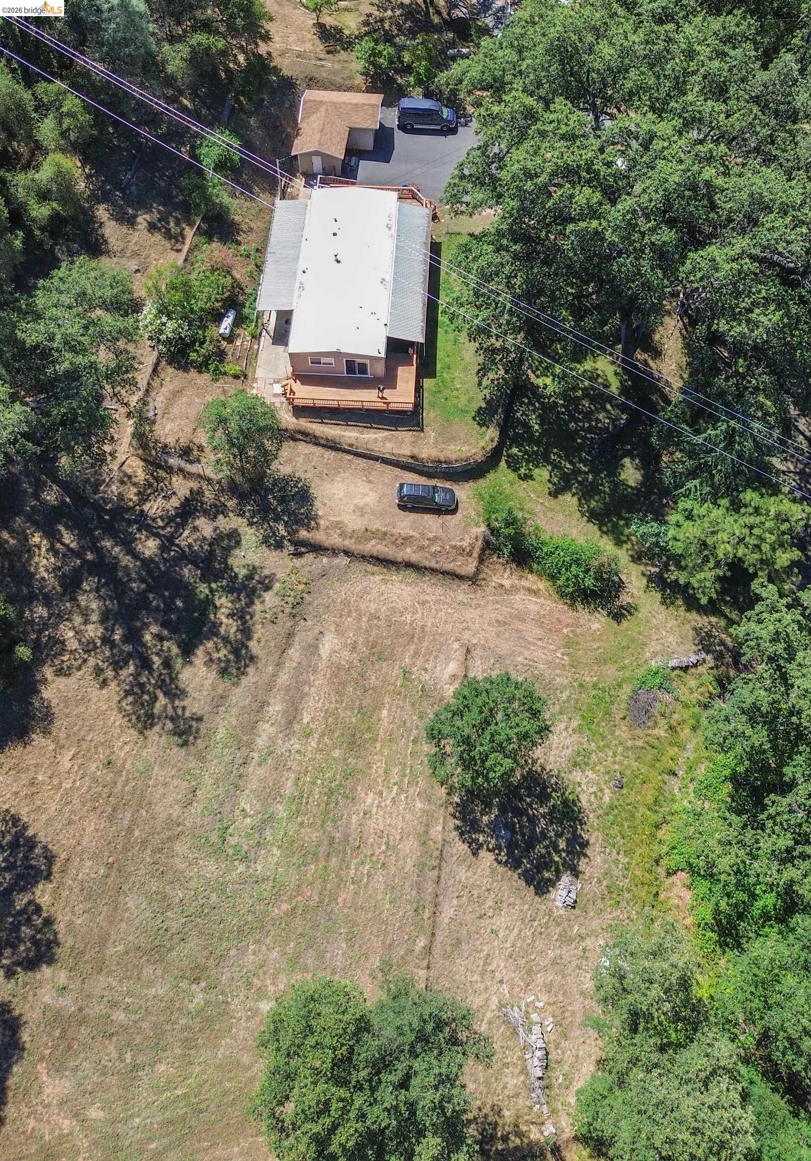 13904 Tuolumne Road Sonora, CA 95370 - Photo 10 of 44 Aerial perspective showcasing a single-story residence with a light-colored roof