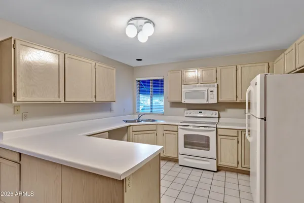 a kitchen with a stove a sink and a refrigerator