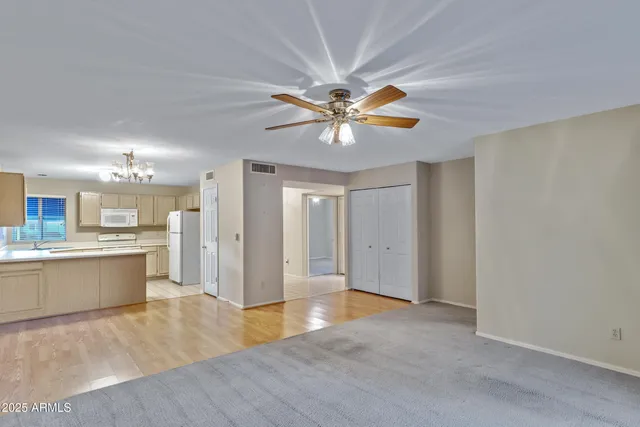 a view of a kitchen with a sink and a chandelier fan