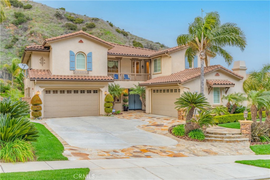 4023 Elderberry Circle Corona, CA 92882 - Photo 38 of 74 a front view of a house with a yard and garage