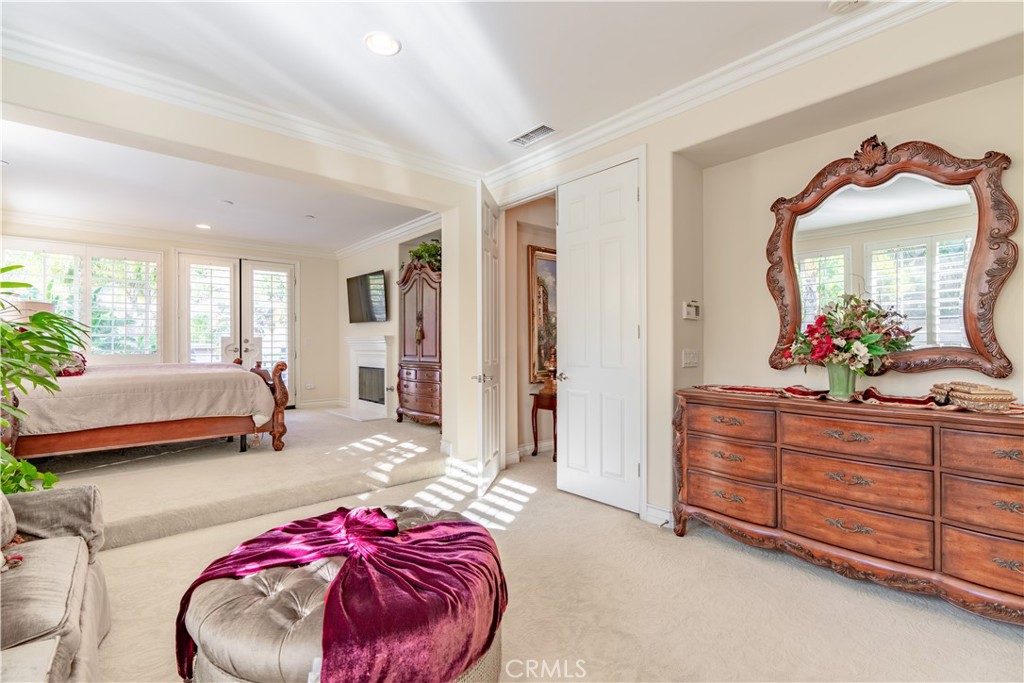 4023 Elderberry Circle Corona, CA 92882 - Photo 42 of 74 a bedroom with a bed and a mirror