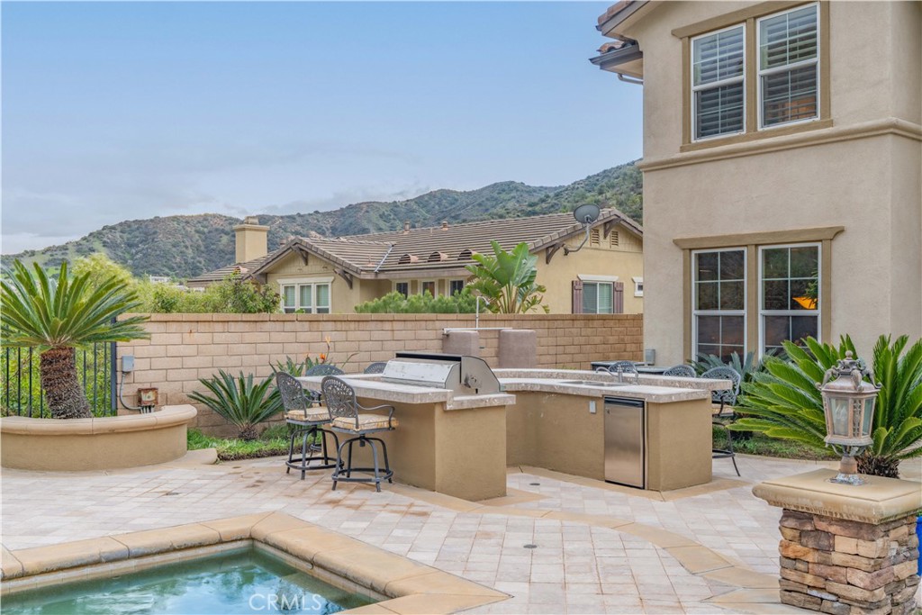 4023 Elderberry Circle Corona, CA 92882 - Photo 64 of 74 a view of a house with pool lawn chairs and a yard