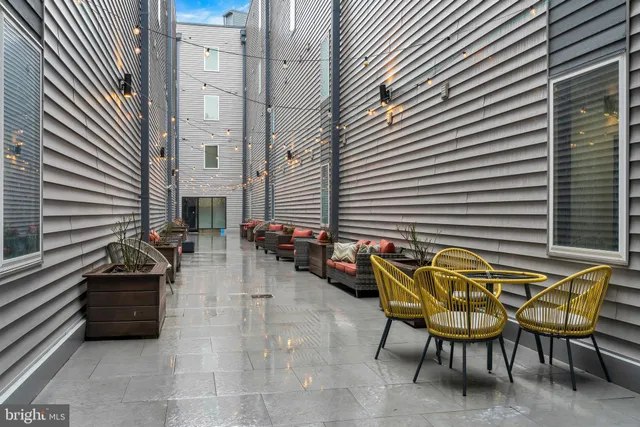 a backyard of a house with table and chairs