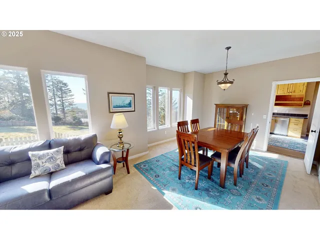 a living room with furniture a dining table and a window