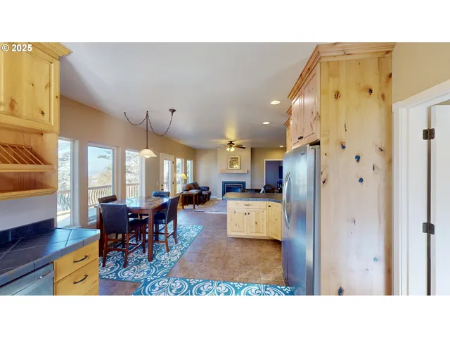 a living room with stainless steel appliances kitchen island granite countertop furniture and a dining table