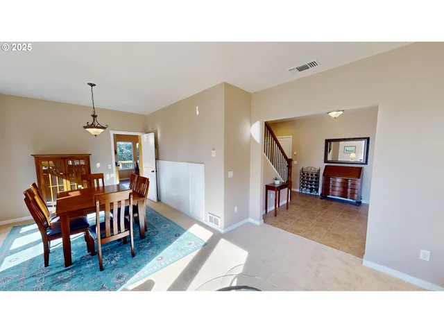 a living room with furniture and a dining table with wooden floor