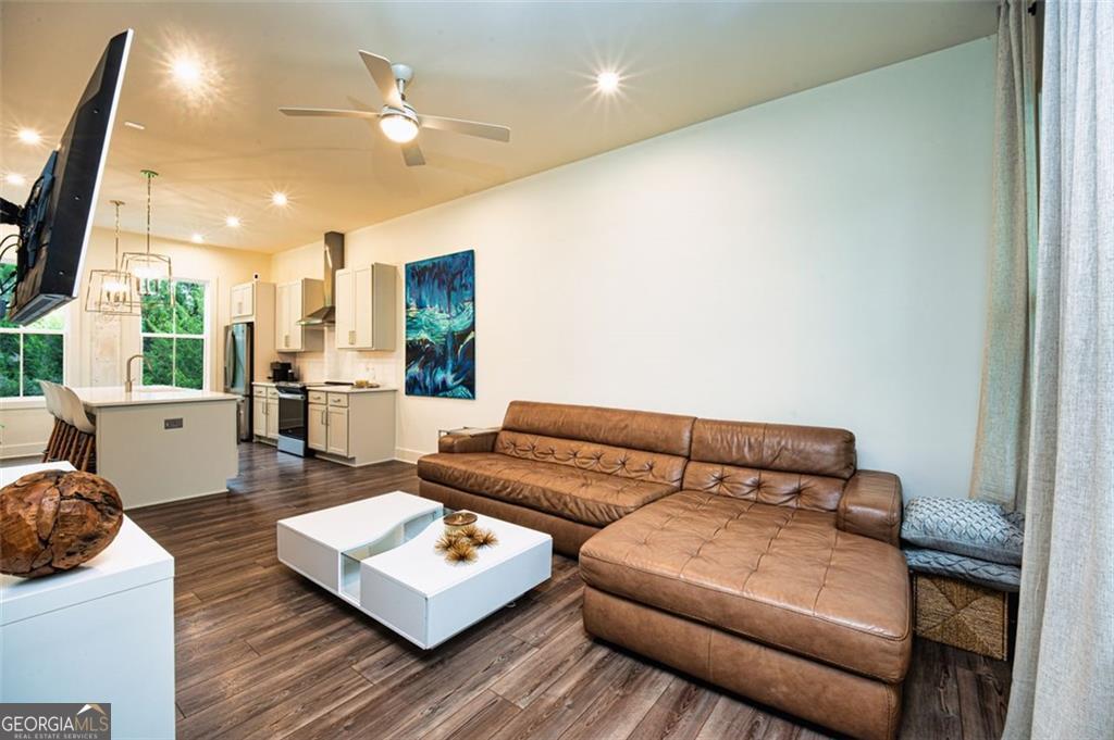 a living room with furniture and a wooden floor