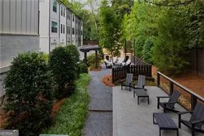 a view of balcony with wooden bench and trees