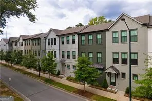 a front view of a residential houses with yard and green space