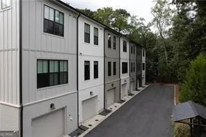 a view of a house with backyard and sitting area