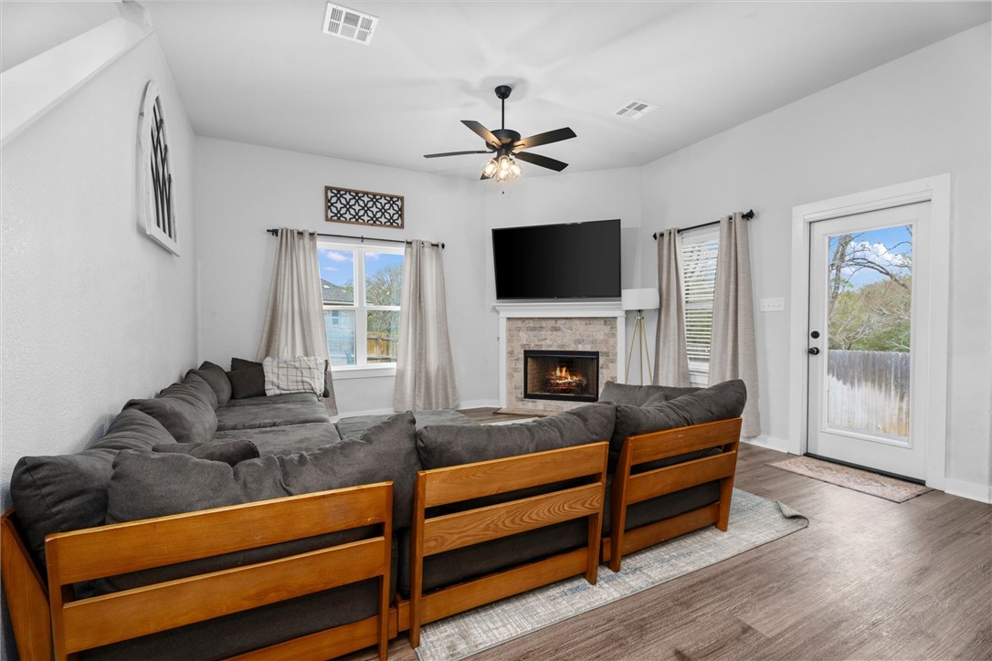 3027 Wolfpack Loop Bryan, TX 77808 - Photo 11 of 39 a living room with furniture flat screen tv and a fireplace