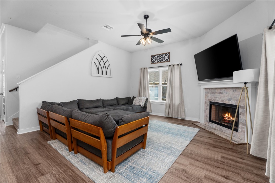 3027 Wolfpack Loop Bryan, TX 77808 - Photo 12 of 39 a living room with furniture a flat screen tv and a fireplace