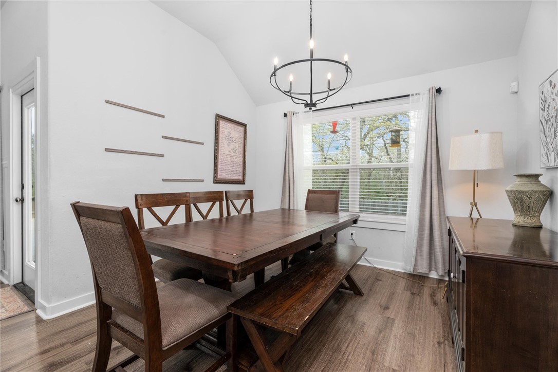 3027 Wolfpack Loop Bryan, TX 77808 - Photo 19 of 39 a view of a dining room with furniture window and wooden floor