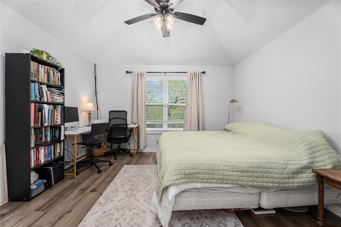 3027 Wolfpack Loop Bryan, TX 77808 - Photo 22 of 39 a bedroom with a bed furniture and a book shelf