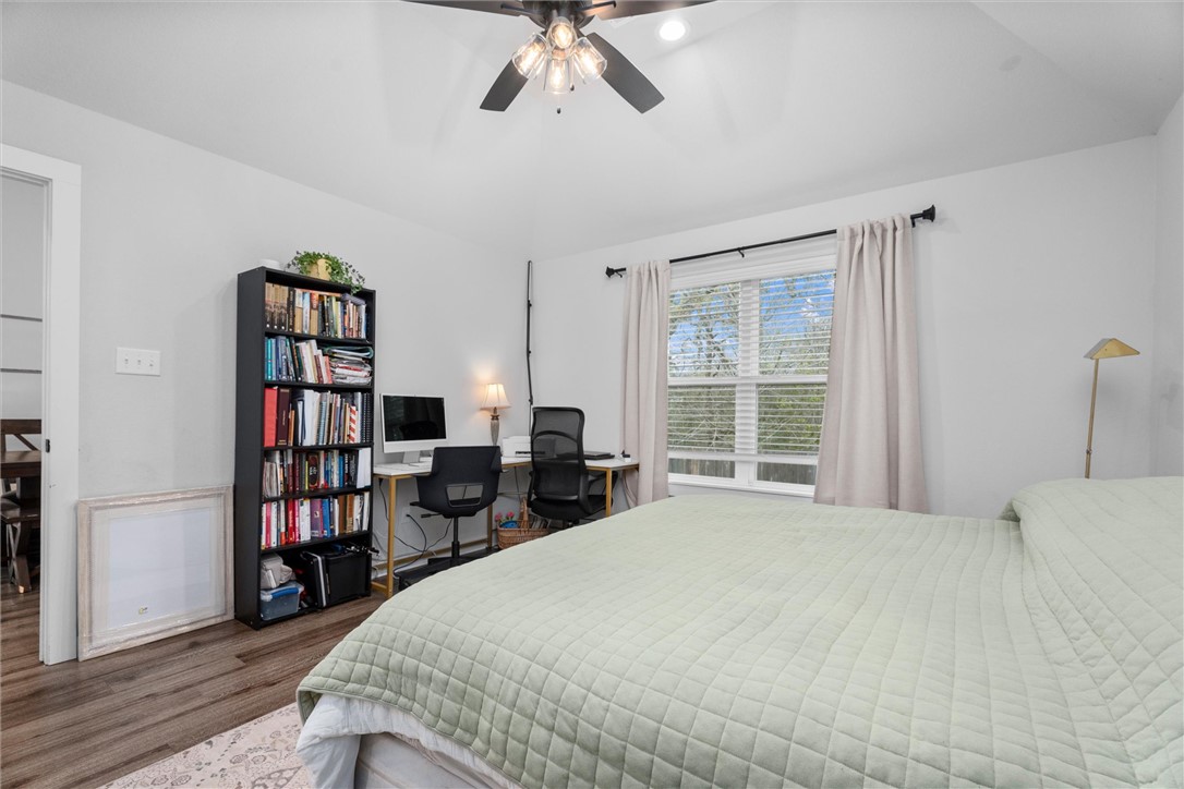 3027 Wolfpack Loop Bryan, TX 77808 - Photo 23 of 39 a bedroom with a large bed and a book shelf