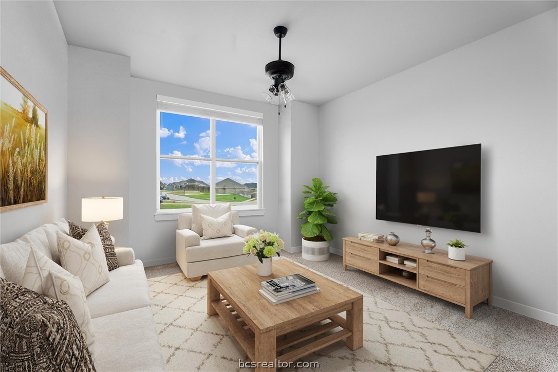 3027 Wolfpack Loop Bryan, TX 77808 - Photo 28 of 39 a living room with furniture and a flat screen tv