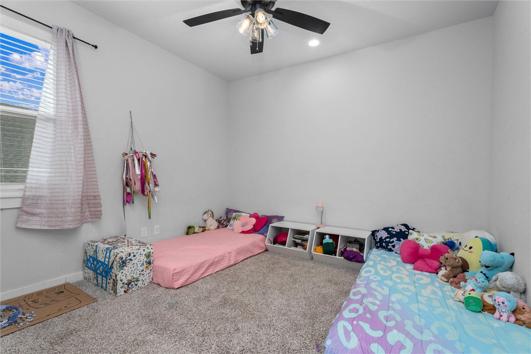 3027 Wolfpack Loop Bryan, TX 77808 - Photo 30 of 39 a bed room with a bed and a chandelier