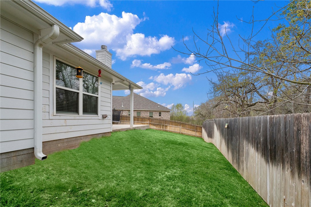 3027 Wolfpack Loop Bryan, TX 77808 - Photo 34 of 39 a view of house with backyard and porch