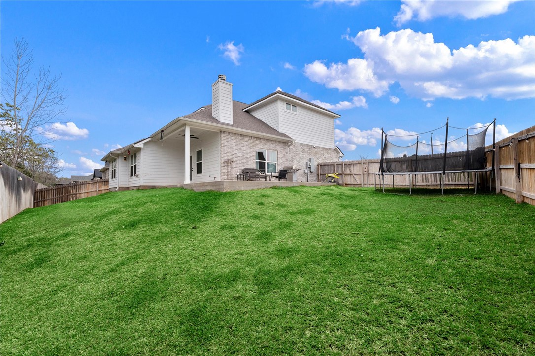 3027 Wolfpack Loop Bryan, TX 77808 - Photo 35 of 39 a view of a house with a yard and sitting area