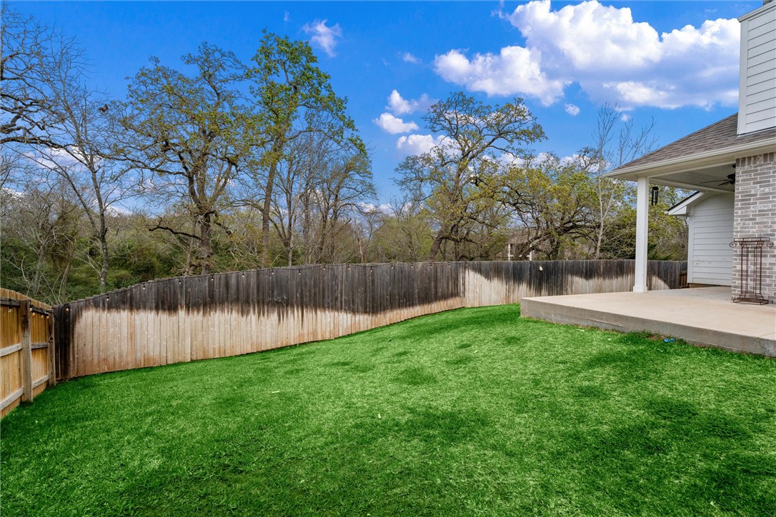 3027 Wolfpack Loop Bryan, TX 77808 - Photo 36 of 39 a backyard of a house with lots of green space