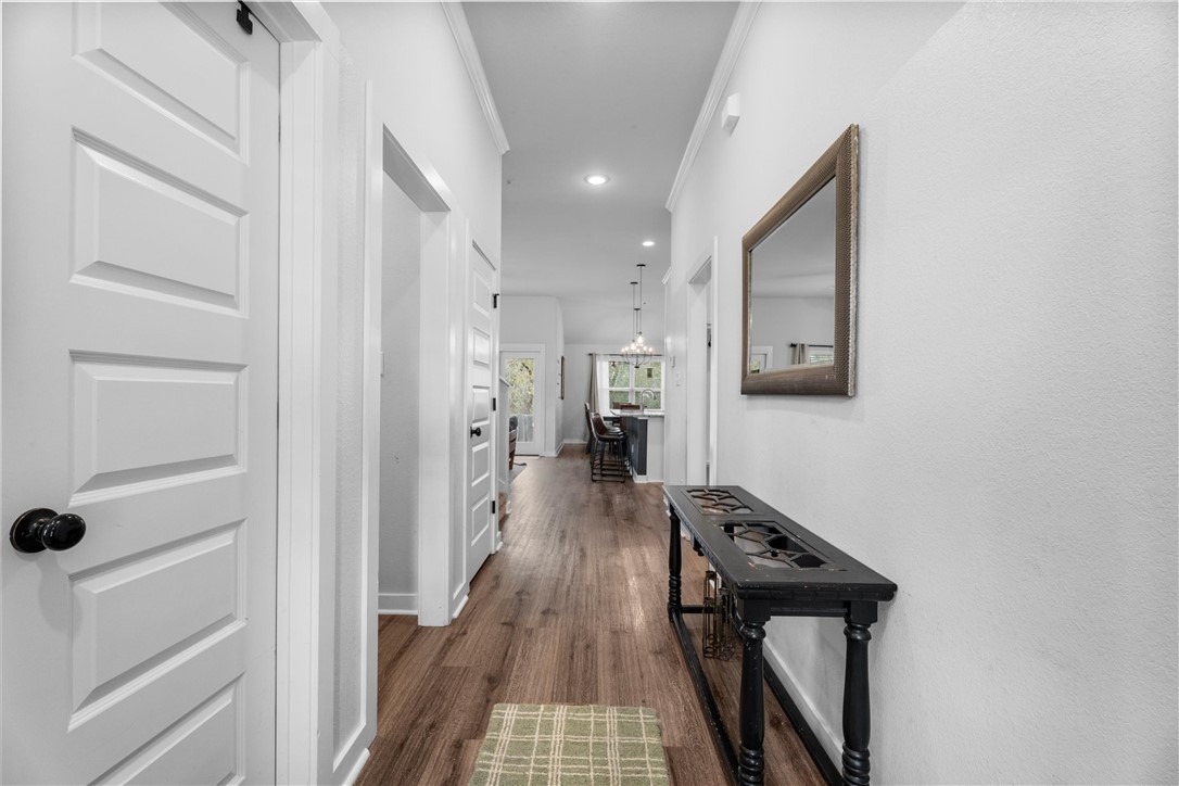 3027 Wolfpack Loop Bryan, TX 77808 - Photo 4 of 39 a view of a hallway with wooden floor and staircase