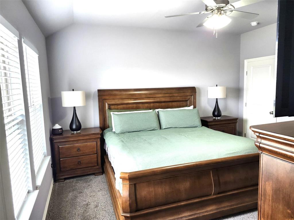 110 Joyce Street Whitney, TX 76692 - Photo 7 of 12 a bedroom with a bed and a lamp