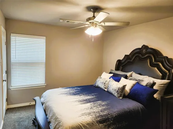 a bedroom with a bed and window