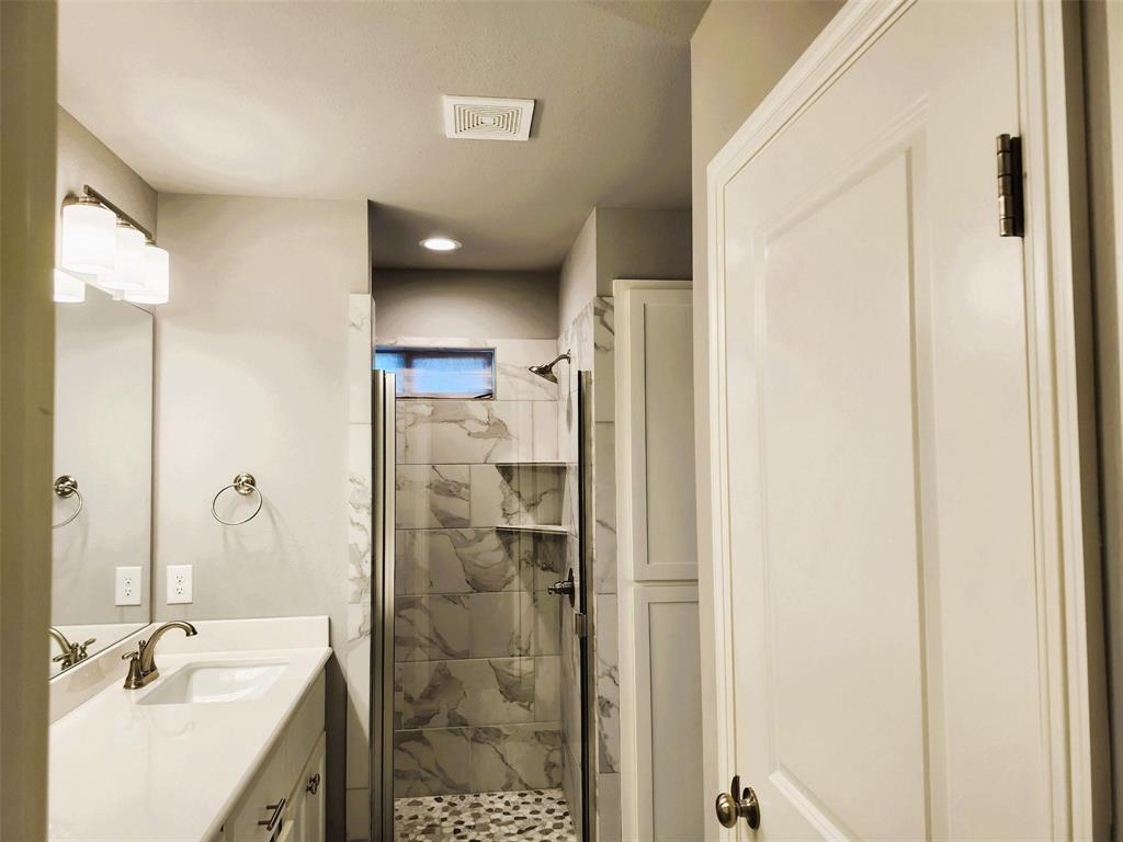 110 Joyce Street Whitney, TX 76692 - Photo 10 of 12 a bathroom with a shower sink and mirror