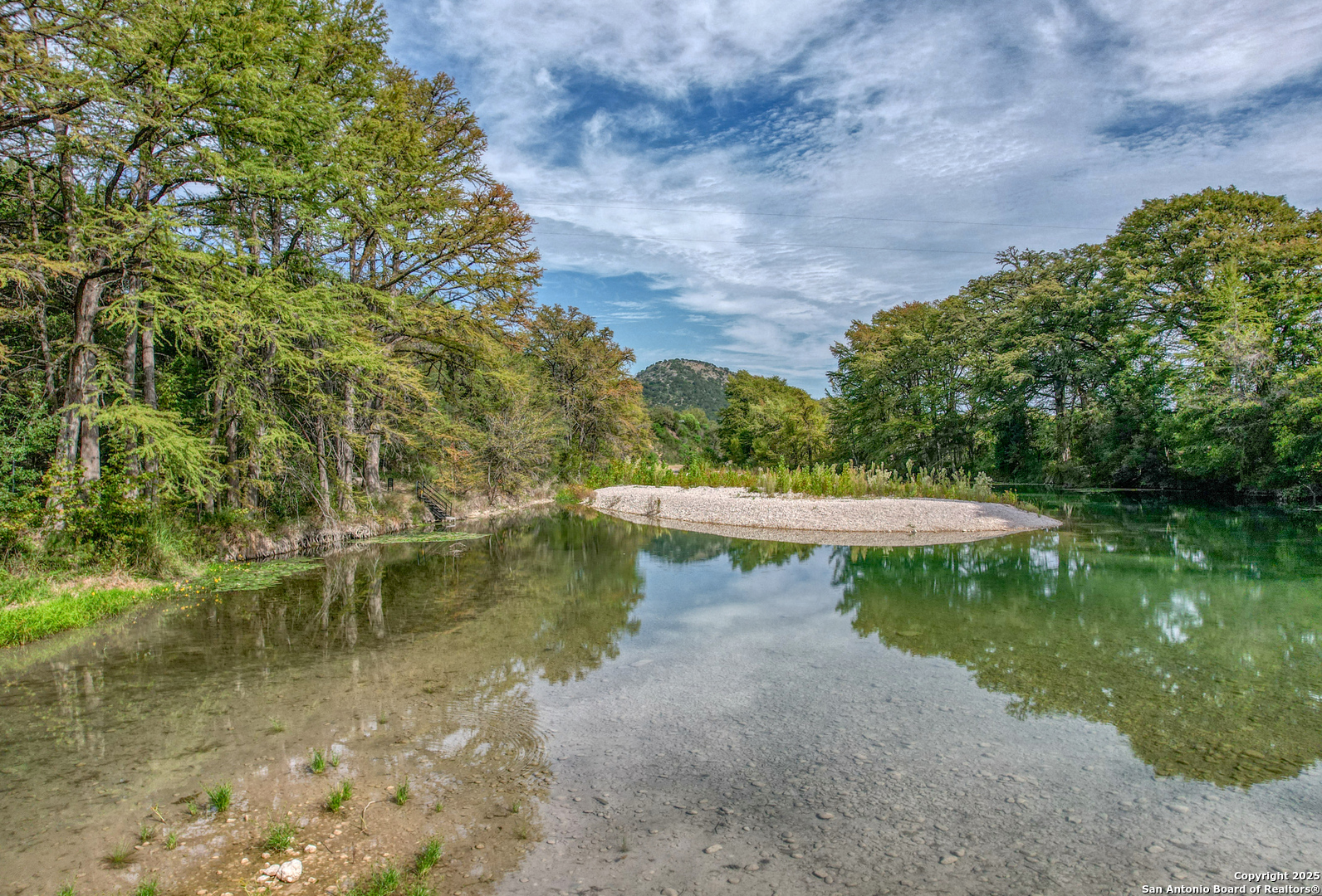 235 Madrone Concan, TX 78838 - Photo 6 of 9 a view of a lake with a yard