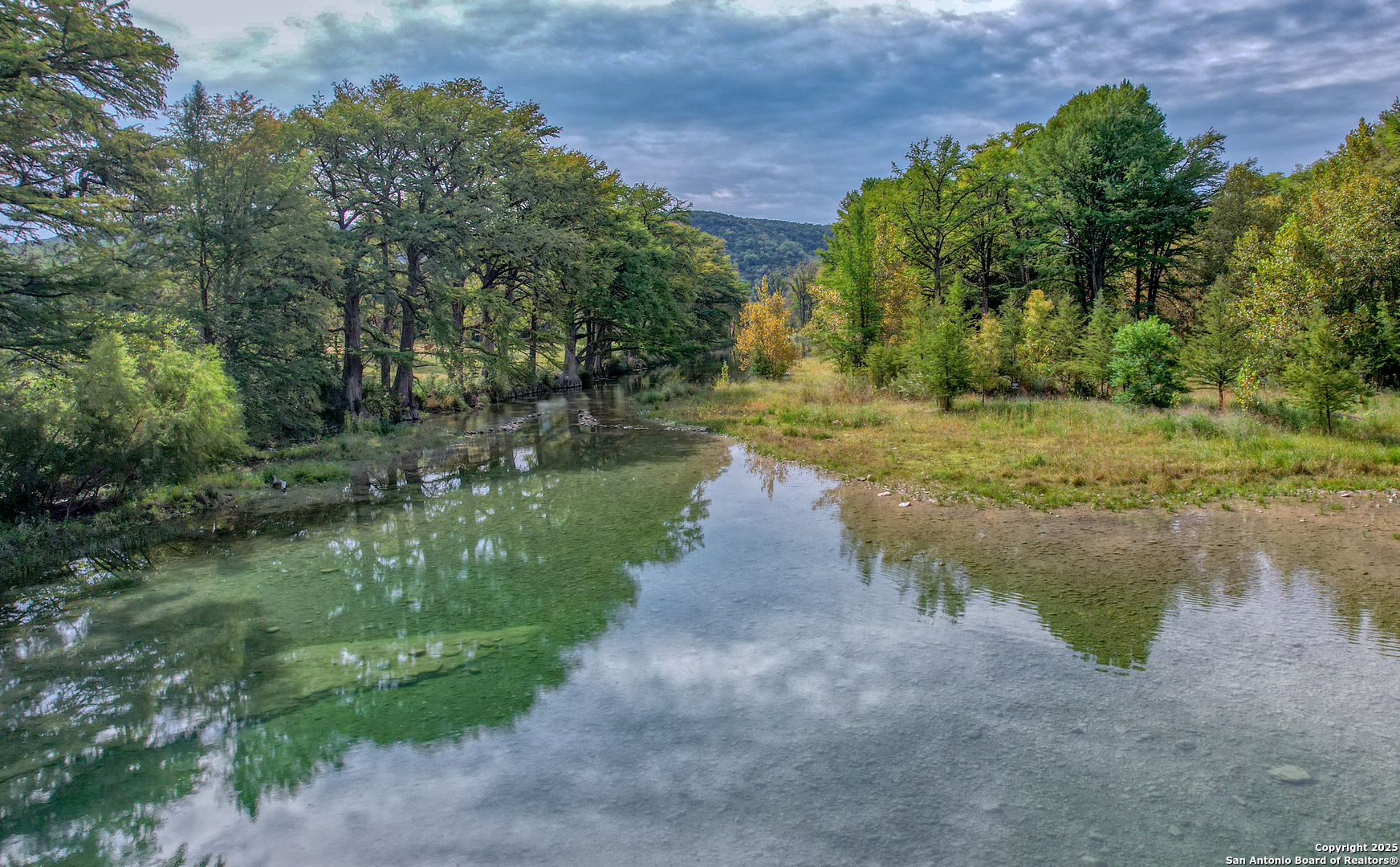 235 Madrone Concan, TX 78838 - Photo 7 of 9 a view of a lake with a yard