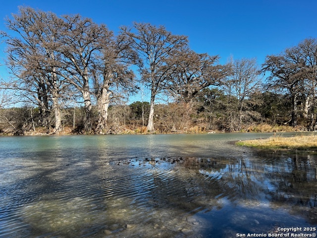 235 Madrone Concan, TX 78838 - Photo 7 of 11 a view of lake with a yard