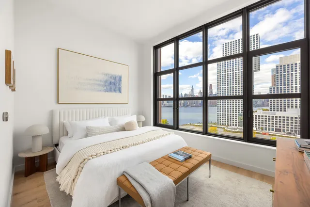 a kitchen with stainless steel appliances granite countertop a table chairs and a refrigerator