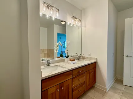 a bathroom with a double vanity sink and a mirror