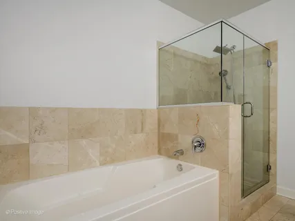 a bathroom with a bathtub and shower