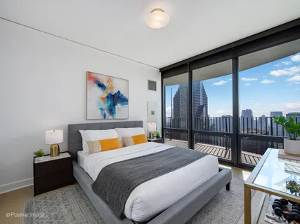 a bedroom with a bed and glass window