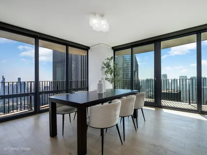 a view of a room with furniture and large windows