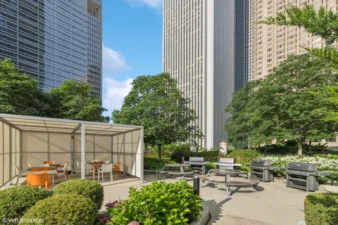a view of a patio with couches chairs and potted plants