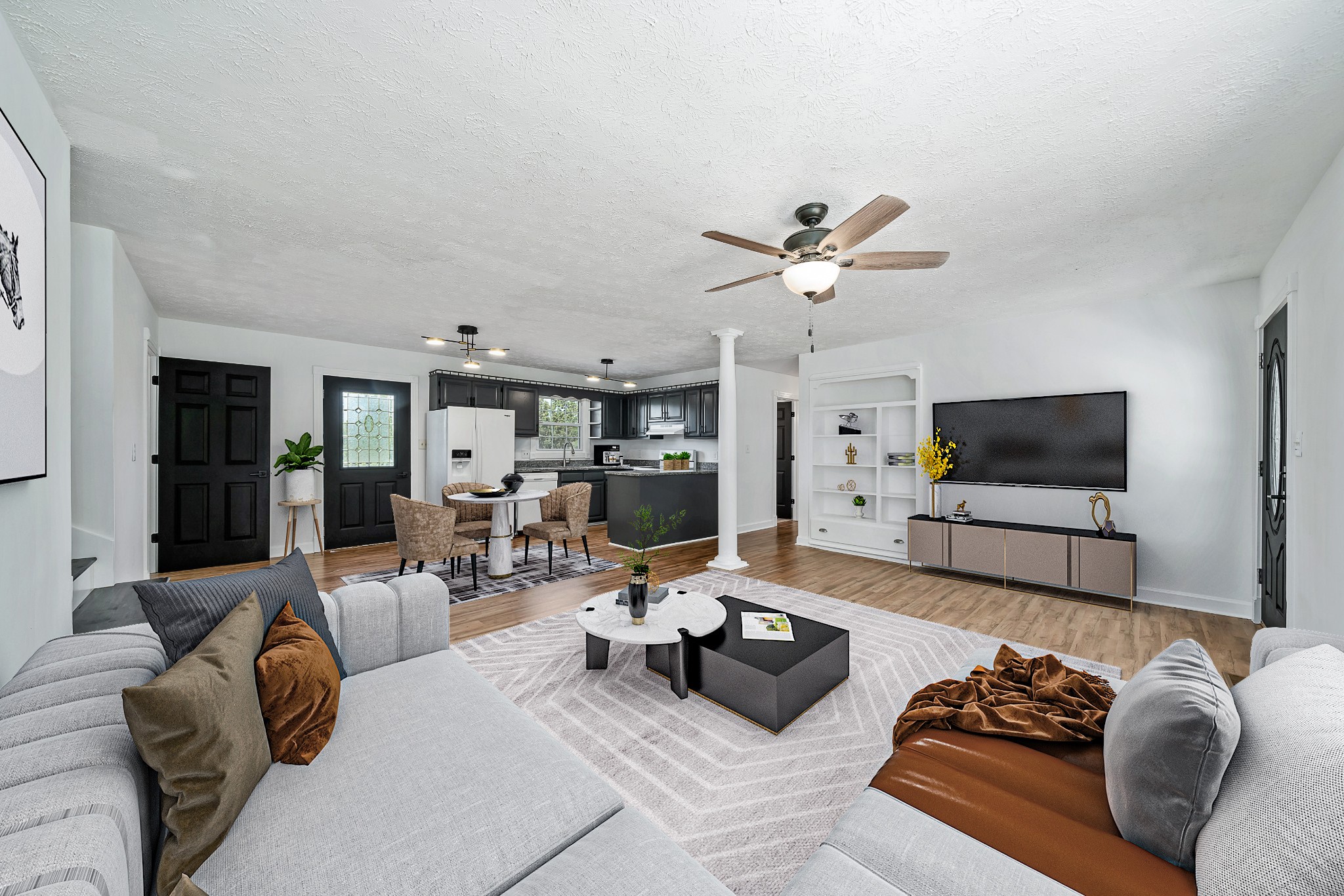 a living room with furniture ceiling fan and a flat screen tv