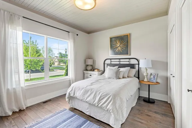 a bedroom with a bed and a window