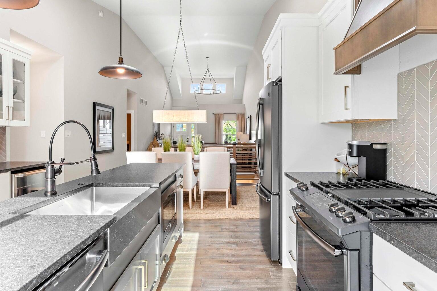 10883 Walnut Drive St. John, IN 46373 - Photo 5 of 30 a kitchen with stainless steel appliances granite countertop a sink a stove and a refrigerator